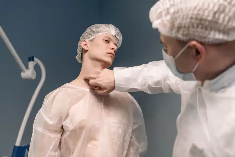 Doctor examining patient neck pain during chronic migraine consultation in pain clinic