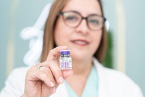 Pain specialist preparing Botox injection for chronic migraine treatment in Plano TX