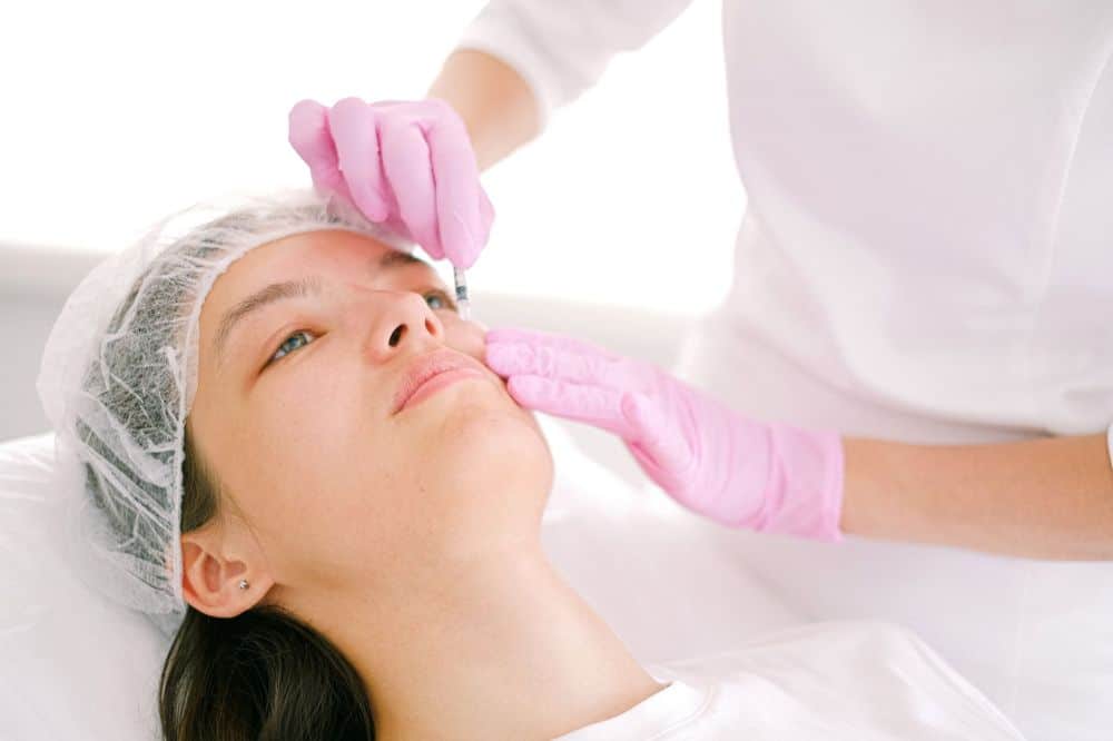 Medical professional performing Botox injection for chronic migraine treatment in clinic