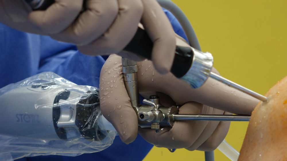 Physician performing radiofrequency ablation procedure using fluoroscopy guidance for back pain