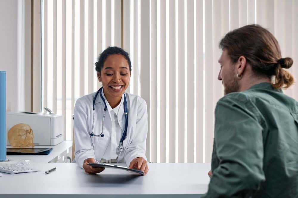 Pain specialist consulting patient about chronic migraine treatment options in Texas