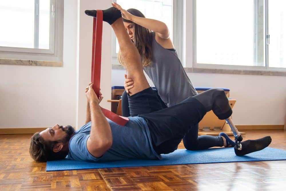 Fibromyalgia & Chronic Pain Management in Plano, TX 2 Physical therapist guiding patient through therapeutic exercises for chronic pain relief