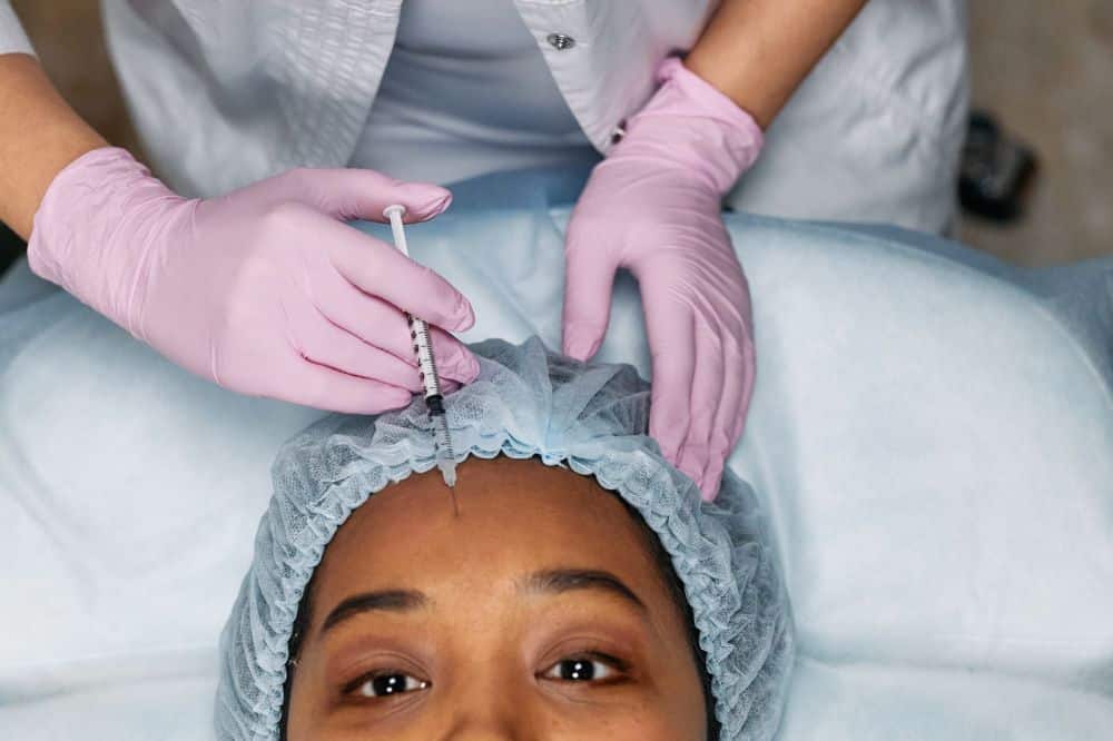 Fibromyalgia & Chronic Pain Management in Plano, TX 3 Medical professional administering Botox injection for chronic migraine treatment in clinic