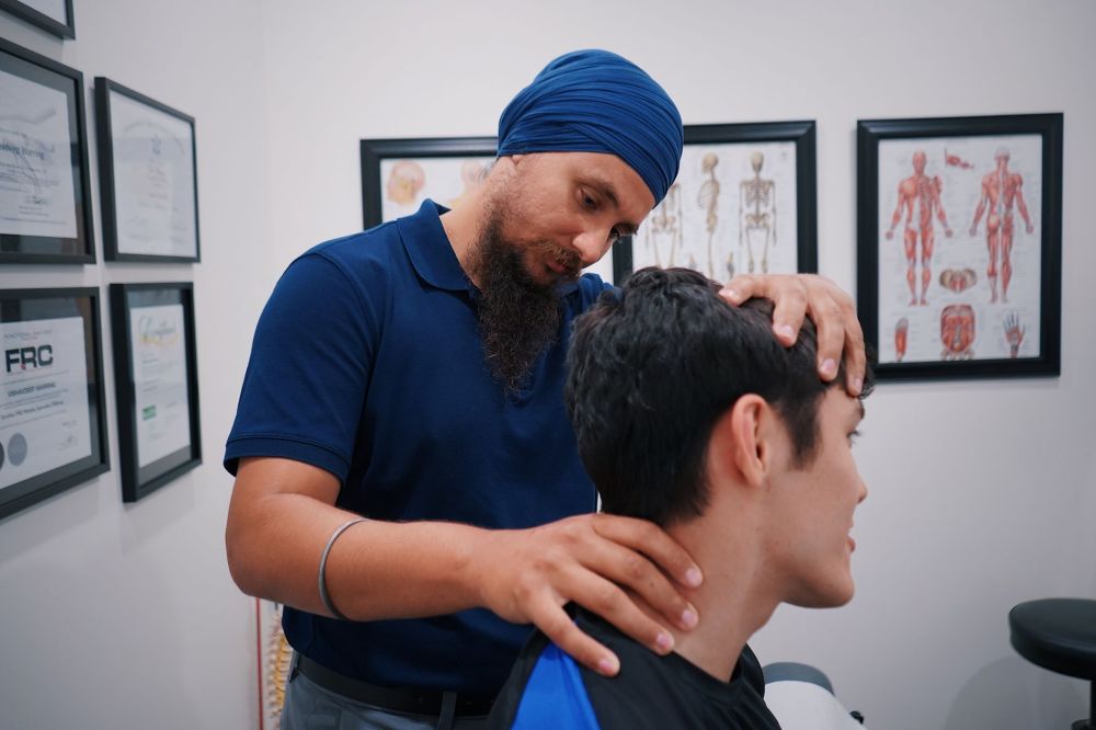 Pain management specialist reviewing a treatment plan with a chronic pain patient