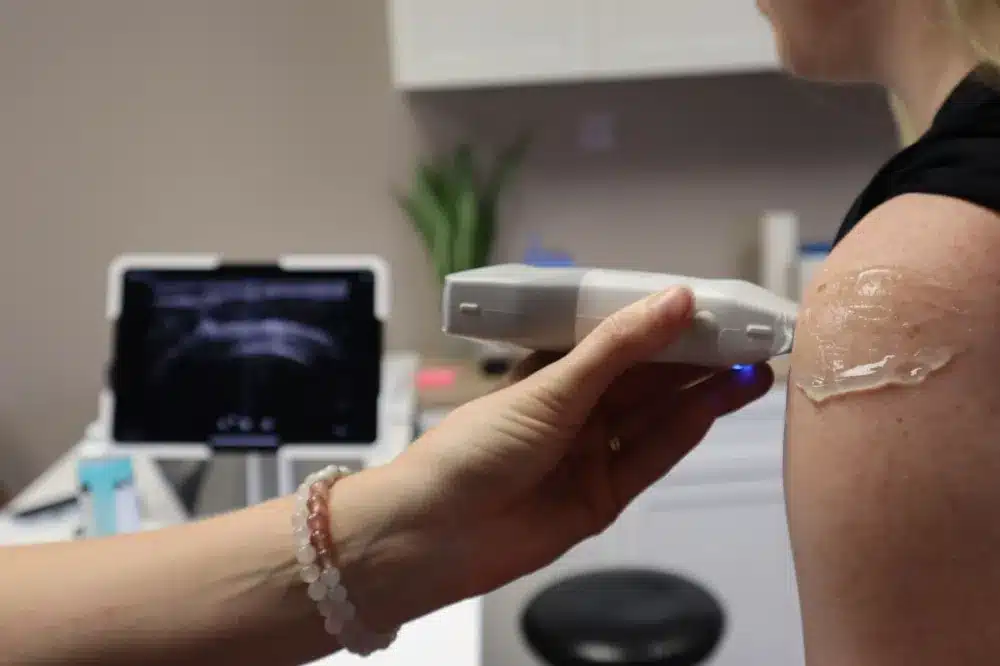 Hip Joint Injection in Grand Prairie, TX | Non-Surgical Options 2 Clinician performing an ultrasound-guided hip injection on a patient