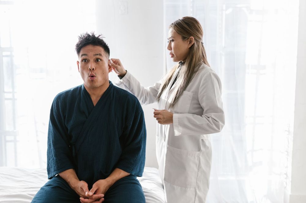 Melatonin & Botox for Chronic Migraines in Grand Prairie, TX 2 Pain specialist consulting a patient about chronic head and neck pain treatment options