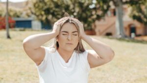 Woman experiencing chronic migraine pain seeking relief at a Grand Prairie TX pain clinic