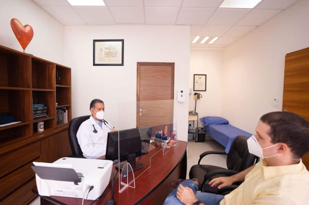 Pain management doctor consulting with patient about migraine treatment options in clinic