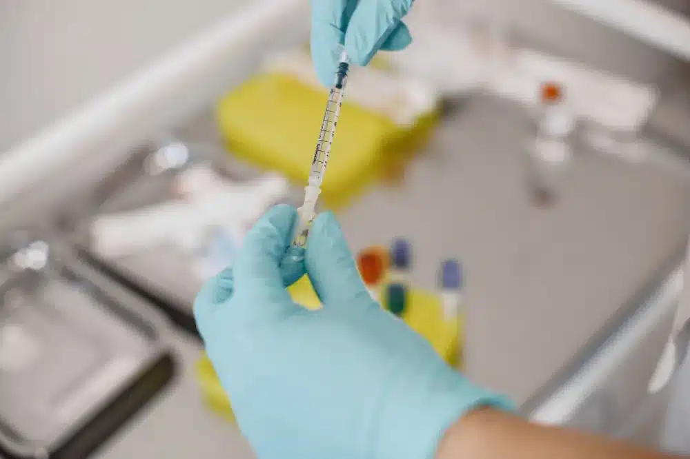 Physician performing a fluoroscopy-guided nerve root block injection in a clinical setting