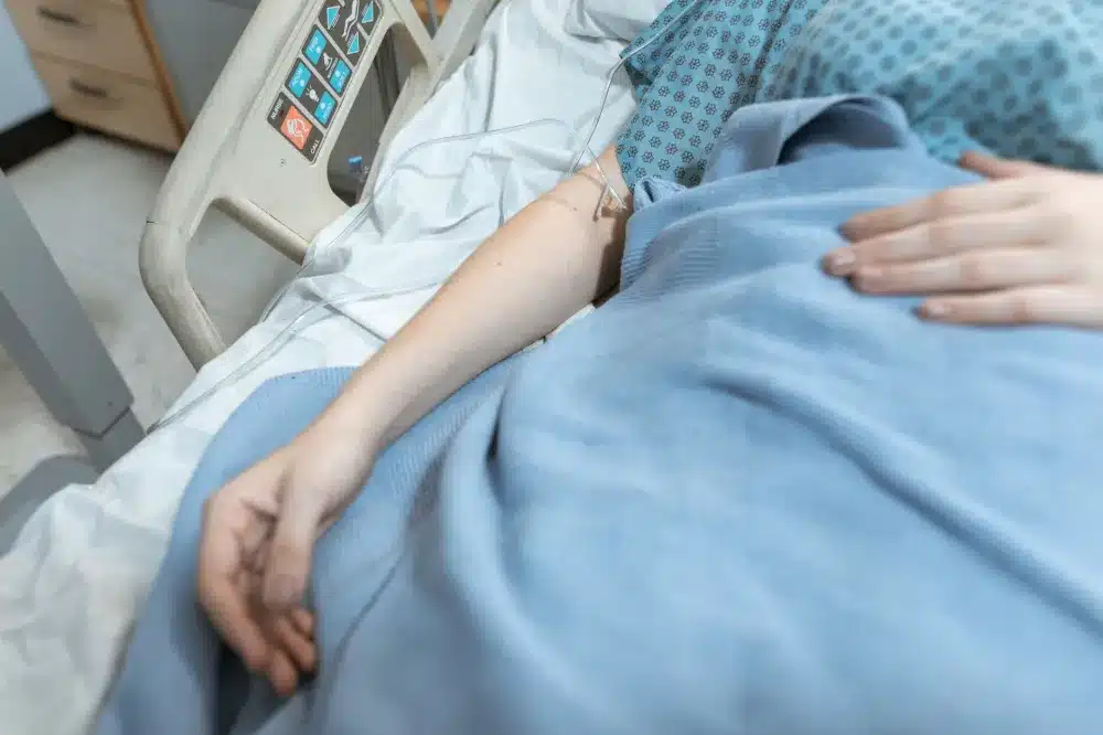 Patient resting comfortably in a recovery area after a minimally invasive nerve block procedure