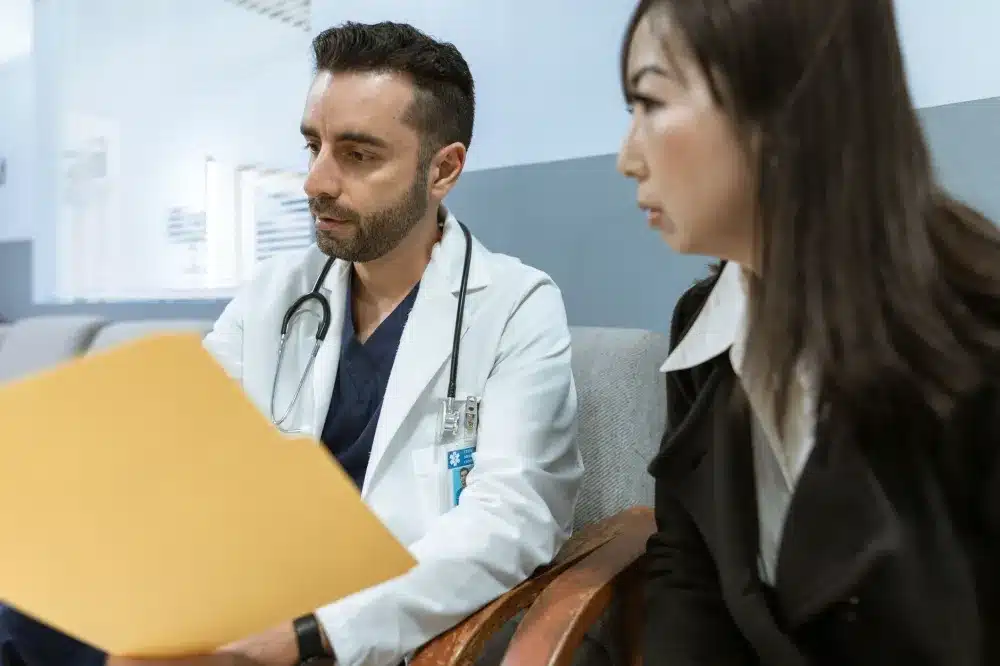 Pain management doctor reviewing a treatment plan with a patient for radiating arm or leg pain