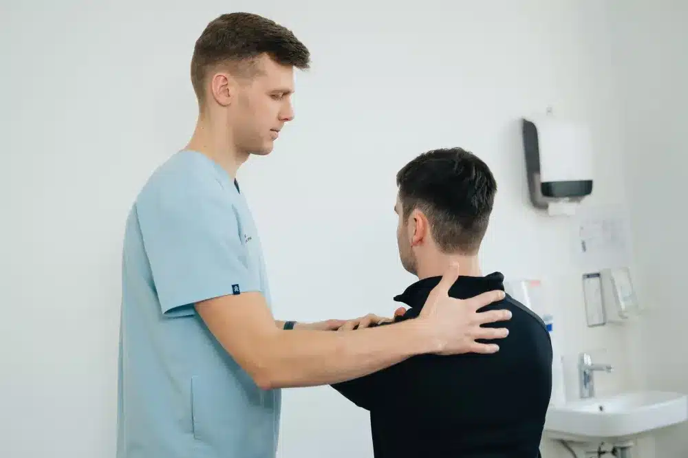 Patient doing guided shoulder physical therapy exercises after a pain injection