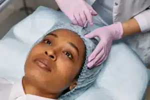 Specialist preparing Botox injection for chronic migraine treatment in Grand Prairie TX clinic