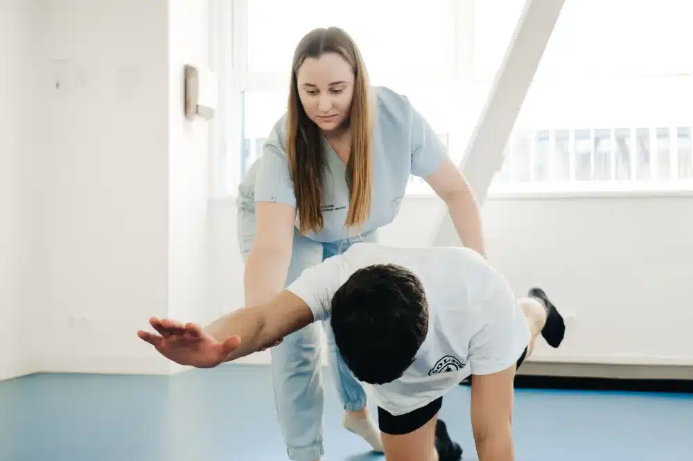 Patient doing gentle hip stretching exercises during physical therapy rehabilitation