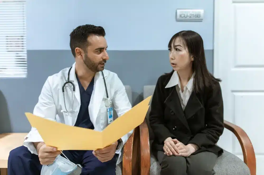 Doctor reviewing treatment plan with a hip pain patient during a follow-up visit