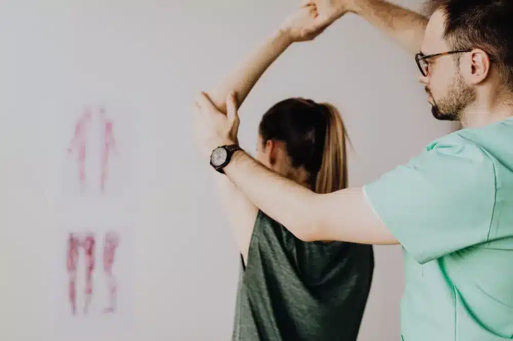 Patient doing guided physical therapy stretches to support back pain recovery after treatment