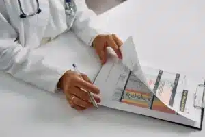 Pain specialist reviewing medication management plan with chronic pain patient in Plano TX clinic