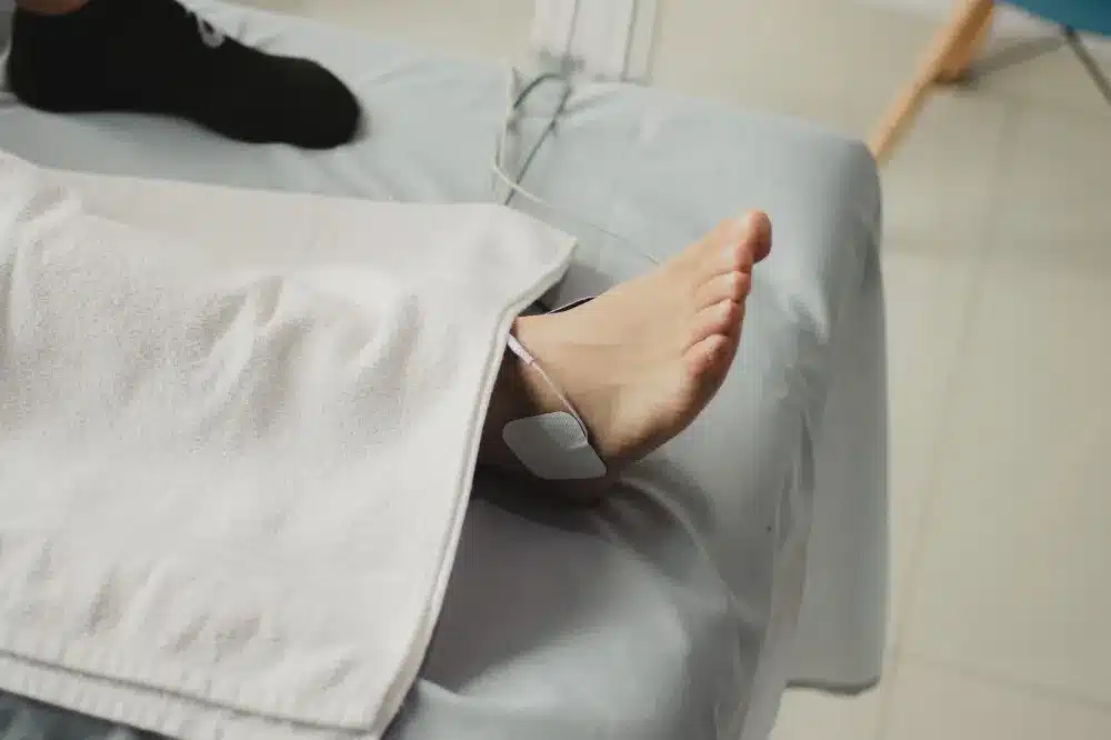 Patient resting comfortably in a clinic chair after a minimally invasive nerve block procedure