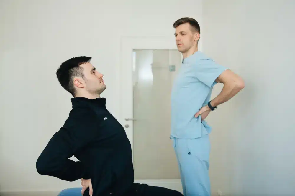 Patient performing guided stretching exercises during physical therapy for spine back pain