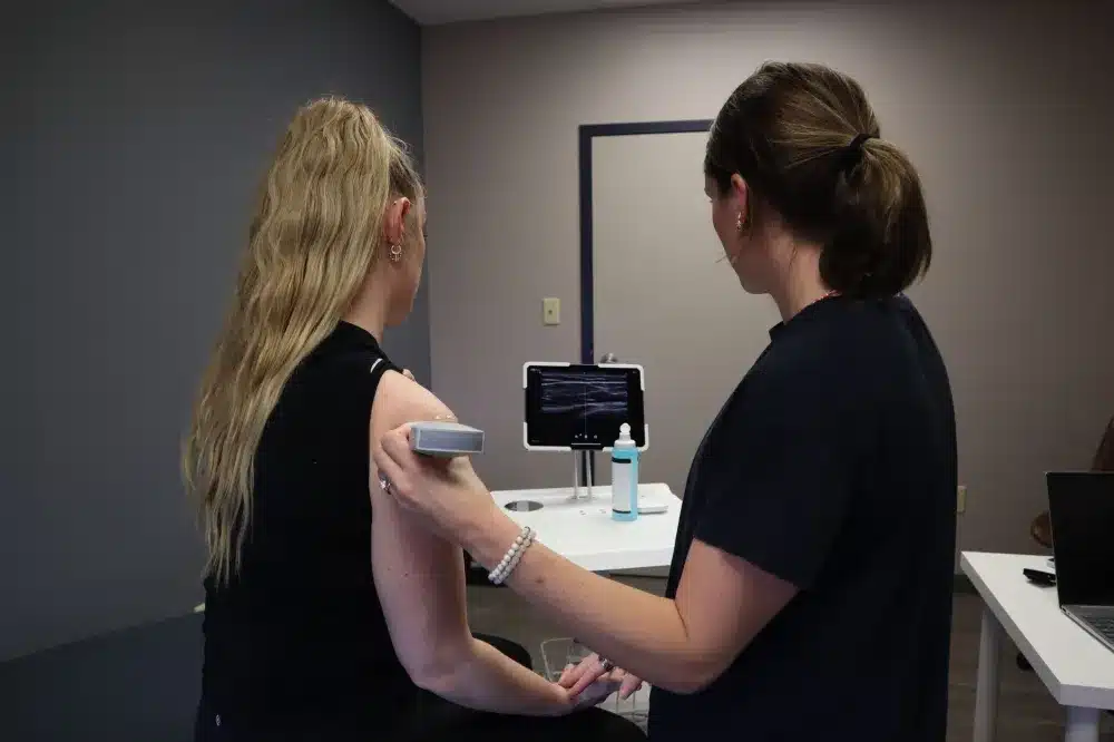 Clinician performing ultrasound-guided injection for tendon injury pain relief