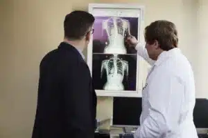 Pain specialist reviewing trigger point injection options with a fibromyalgia patient in Plano TX